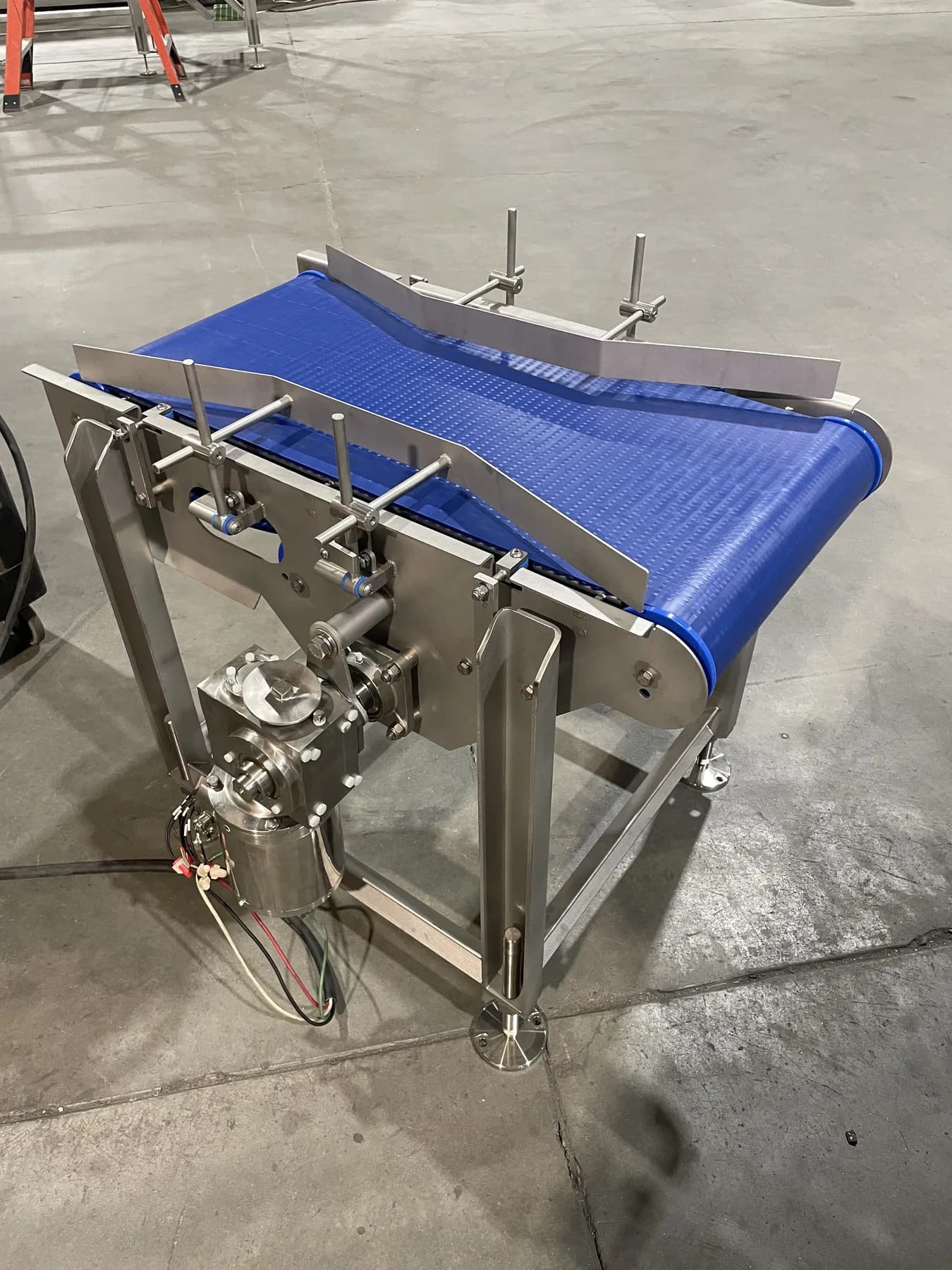 Guided stainless belt conveyor with adjustable side rails and pneumatic components