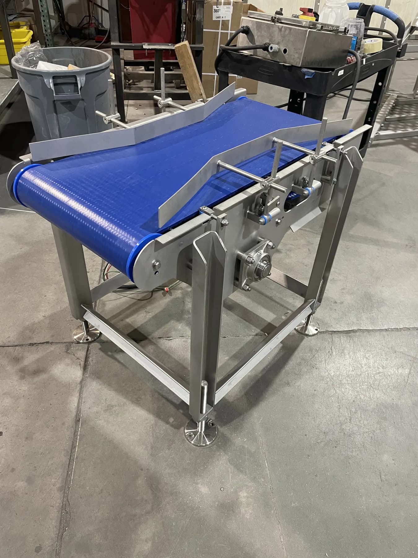 Side view of stainless conveyor frame and guide rail assembly