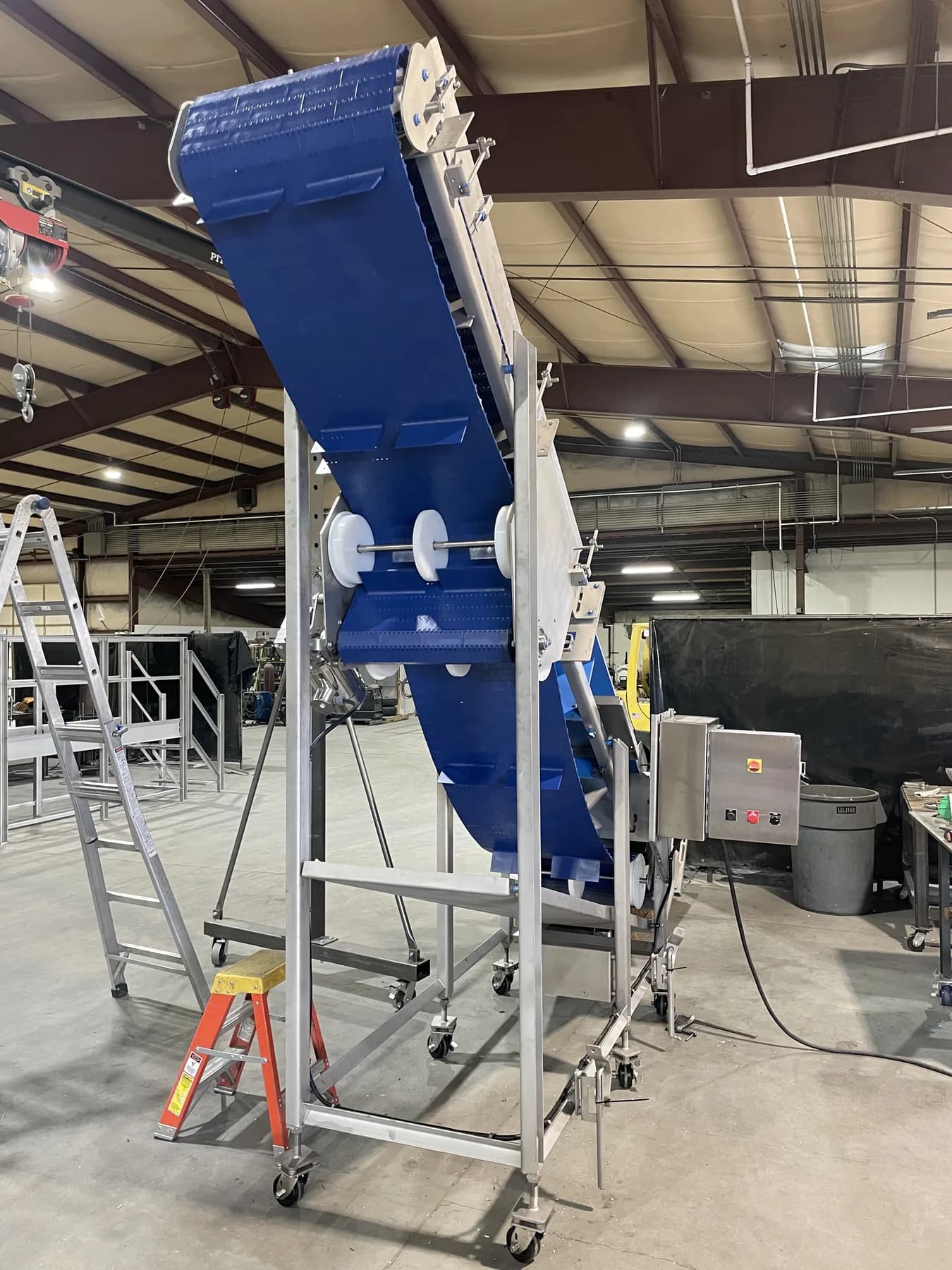 Rear view of high-angle conveyor and stainless support frame
