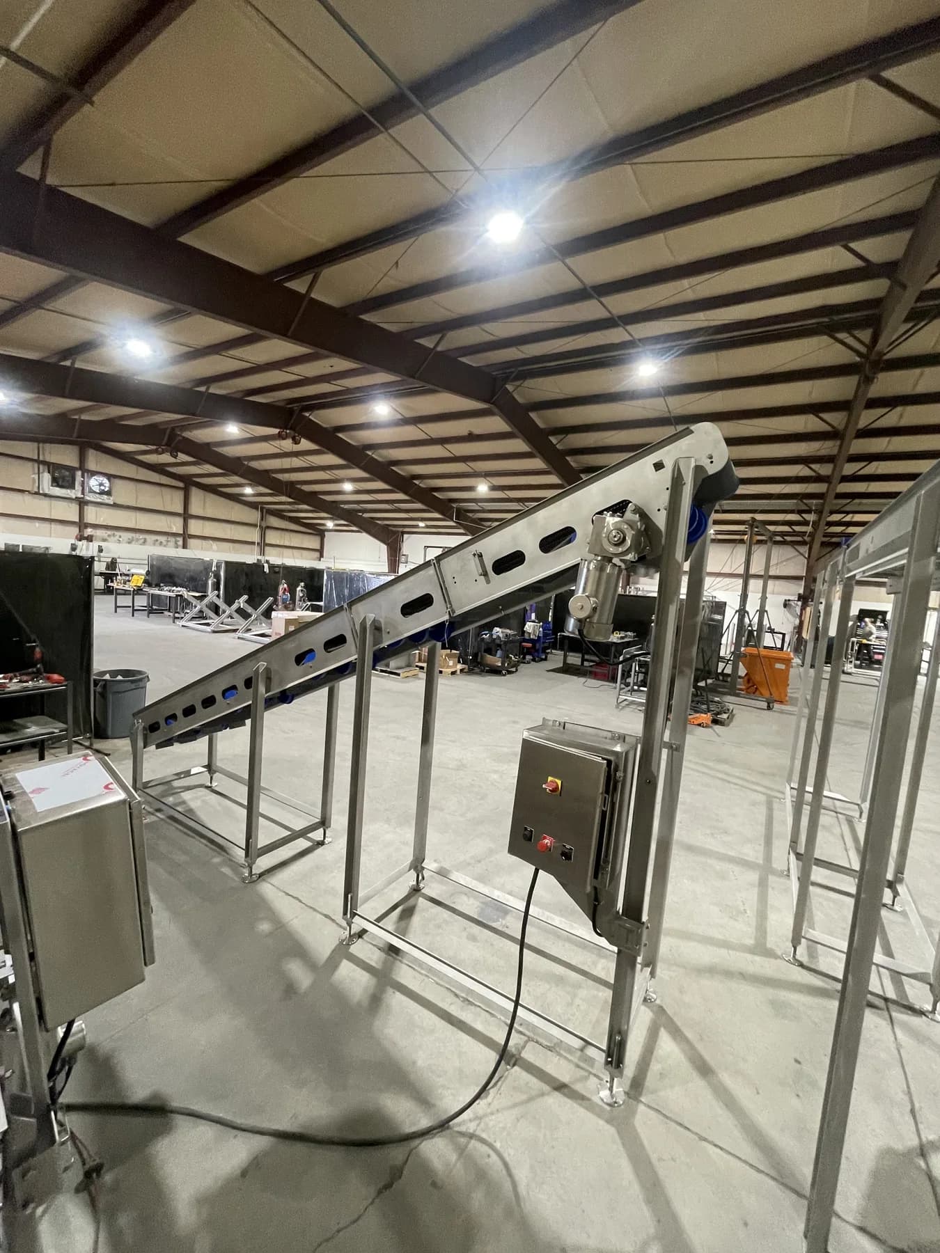 Opposite-side view of long incline conveyor and drive enclosure