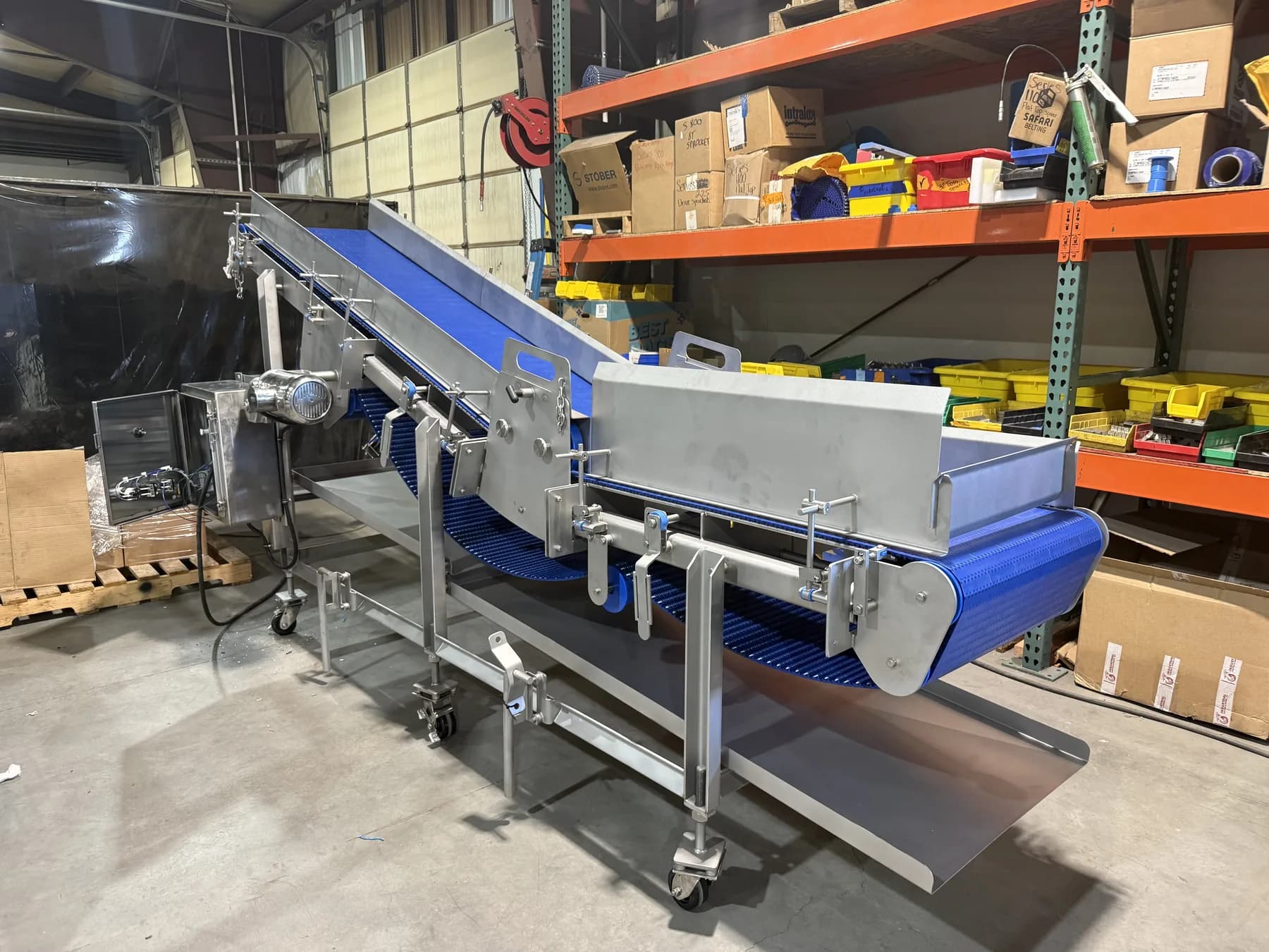 Side view of stainless incline conveyor and horizontal infeed section
