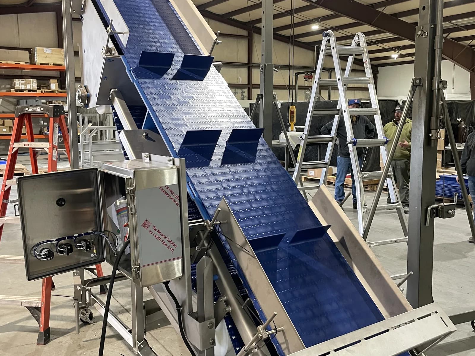High-angle modular incline conveyor with stainless frame and blue belt